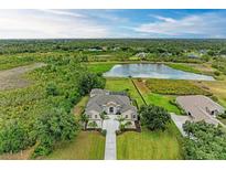 Expansive waterfront home featuring lush landscaping, mature trees and scenic views at 8103 Snowy Egret Pl, Bradenton, FL 34202