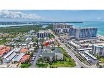Stunning aerial view of the property near the waterfront, with lush landscaping, city views and ample parking at 845 Benjamin Franklin Dr # 302, Sarasota, FL 34236