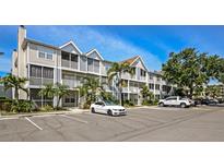 Attractive condo building with well-manicured landscaping and ample parking on a sunny day at 850 S Tamiami Trl # 431, Sarasota, FL 34236