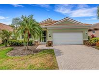 Charming single-story home with a red tile roof and lush landscaping at 212 River Enclave Ct, Bradenton, FL 34212