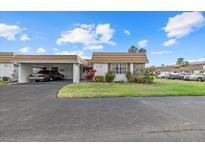 Charming single-story home with carport and manicured front lawn in a quiet neighborhood at 2749 Riverbluff Pl # V65, Sarasota, FL 34231