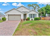 Charming single-story home with a well-manicured lawn and a brick-paved driveway at 3924 Candia Ave, North Port, FL 34286