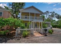 Charming two-story home with a white picket fence and well-maintained landscaping, plus a covered parking area at 508 Howard Ct, Sarasota, FL 34236