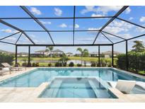 Screened-in pool and spa overlooking the water create a relaxing backyard oasis at 5117 Marina Basin Ct, Bradenton, FL 34211