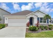 Charming single-story home featuring a two-car garage, well-maintained landscaping, and a welcoming front entrance at 5121 Sultana Cv, Bradenton, FL 34211