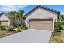 Charming single-Gathering home featuring a two-car garage, well-maintained landscaping, and a paved driveway at 5985 Amberly Dr, Bradenton, FL 34208