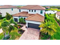 Beautiful two-story home with a tile roof, three-car garage, and lush landscaping at 13112 Swiftwater Way, Bradenton, FL 34211