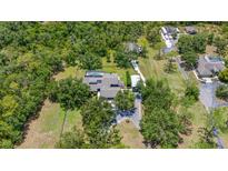 Aerial view of a private estate featuring a pool, long driveway, and mature trees at 140 Cowpen Ln, Sarasota, FL 34240