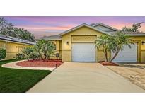 Charming home featuring a well-manicured lawn, lovely landscaping and an attached two car garage at 203 28Th W St, Palmetto, FL 34221