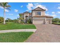 Stately two-story home featuring a three-car garage, tile roof and paved driveway with lush landscaping at 20831 Valprato Ct, Venice, FL 34293
