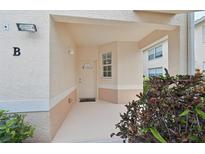 Welcoming front porch and door with glass window and neutral stucco walls provide a warm entrance at 4254 Vicenza Dr # B, Venice, FL 34293