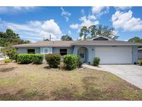 Charming single-story home with a well-manicured lawn and attached two car garage at 4405 Linwood St, Sarasota, FL 34232
