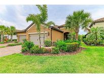 Charming single-story home with lush landscaping, mature palms, and a two-car garage at 4416 Amalfi Ave, Sarasota, FL 34243