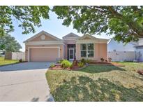 Charming single-story home with a well-manicured lawn, mature trees, and a two-car garage at 4627 56Th E Dr, Bradenton, FL 34203