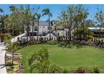 Stunning home with a lush green lawn, mature trees and manicured landscaping creating a picturesque setting at 705 89Th Nw Ct, Bradenton, FL 34209