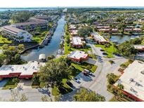 Expansive aerial view of waterfront community with docks, lush landscaping, and waterway access to the ocean at 9409 Catalina Dr, Bradenton, FL 34210