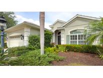 Well maintained home with beautiful landscaping and lush tropical plants in the front yard at 12240 Thornhill Ct, Lakewood Ranch, FL 34202