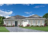 A charming one-story home featuring a three car garage, well manicured yard, and ample windows at 17719 Palmiste Dr, Bradenton, FL 34202