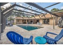 Inviting covered pool and patio area features in-ground pool and outdoor furniture at 1809 Buccaneer Ter, Sarasota, FL 34231