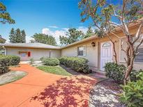 Exterior home view, featuring front door, manicured bushes, and landscaped walkway at 2188 Corinne S Ct # A, St Petersburg, FL 33712