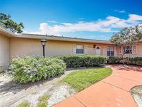 Beautiful exterior view of the home's front, showing the front lawn and walkway at 2188 Corinne S Ct # A, St Petersburg, FL 33712