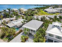 Beautiful aerial view of a coastal community featuring lush landscaping and stunning waterfront properties at 229 S Harbor Dr, Holmes Beach, FL 34217