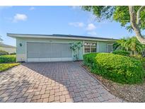 Charming single-story home showcasing a brick driveway and well-maintained landscaping at 2607 Lancaster Dr # 35, Sun City Center, FL 33573
