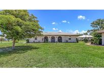 Charming single-story home with a well-manicured lawn and beautiful landscaping at 445 Matisse S Cir # 445, Nokomis, FL 34275