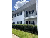 Two-story condo with white walls, black shutters, and a well-maintained hedge in front at 4511 3Rd Street W Cir # 289, Bradenton, FL 34207