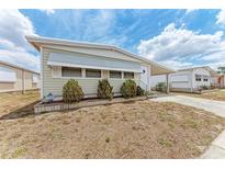 Charming single-story home featuring a covered carport and well-maintained landscaping at 5619 Bayshore Rd # 164, Palmetto, FL 34221