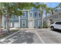 Inviting two-story condo with reserved parking, landscaping, and a covered entryway at 5681 Bidwell Pkwy # 102, Sarasota, FL 34233
