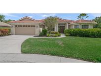 Charming single-story home featuring a tile roof, well-manicured lawn, and a two-car garage at 6664 Deering Cir, Sarasota, FL 34240
