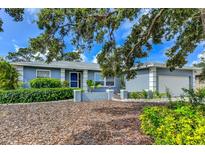 Charming single-story home featuring a manicured lawn, tidy landscaping, and an attached two-car garage at 7719 9Th Avenue Nw Dr, Bradenton, FL 34209
