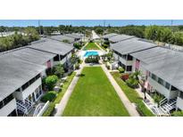 This aerial shows the community buildings, manicured lawn, landscaping, and community pool at 2507 Beneva Rd # 2, Sarasota, FL 34232