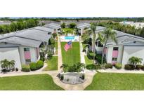 Aerial view of condominiums with well-kept grounds, community pool, landscaping and central flagpole at 2507 Beneva Rd # 2, Sarasota, FL 34232