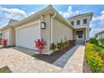 Charming exterior view of home featuring a one-car garage and manicured landscaping at 251 Okeeffe Cir, Bradenton, FL 34212