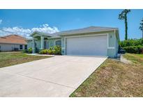 Charming single-story home with a well-maintained lawn and a spacious two-car garage at 2759 Starview Ave, North Port, FL 34288