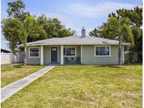 Charming single-story home featuring a well-maintained lawn and inviting front porch seating area at 3102 16Th W Ave, Bradenton, FL 34205