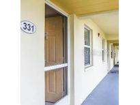 Hallway leading to unit door featuring well-lit corridor and unit number at 433 Cerromar Ln # 331, Venice, FL 34293