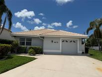 Charming single-story home showcasing a well-manicured lawn, clean driveway, and a neutral color palette at 4613 Muirfield Dr, Bradenton, FL 34210