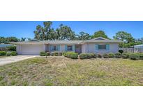 Charming one-story home with a well-manicured lawn, blue shutters, and an attached garage at 5706 10Th Avenue Dr W, Bradenton, FL 34209