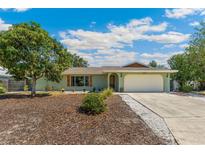 Charming single-story home with an attached garage, lush landscaping, and inviting curb appeal at 6708 11Th Nw Ave, Bradenton, FL 34209