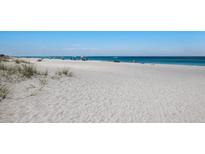 Wide sandy beach with tranquil ocean views, perfect for relaxation and recreation at 7000 Gulf Dr # 205, Holmes Beach, FL 34217