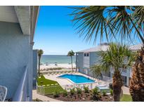 Bright resort featuring a pool and beach with gulf views in a tropical setting at 7000 Gulf Dr # 205, Holmes Beach, FL 34217