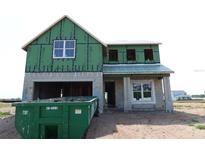 New construction home showing Zip System sheathing, window installation and a large trash container at 721 Anegada Ln, Sarasota, FL 34234
