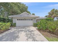 Lovely home featuring a two-car garage and a well maintained landscaped front yard at 1432 Colony Pl, Venice, FL 34292