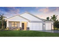 Charming single-story home featuring a two-car garage, well-manicured lawn, and a welcoming front porch at 18428 Dayspring Pl, Venice, FL 34293