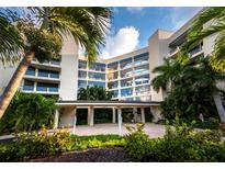 Beautiful condominium building surrounded by lush tropical landscaping and sunny skies at 2120 Harbourside Dr # 617, Longboat Key, FL 34228