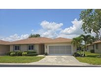 Charming single Gathering home with a well-manicured front lawn, a neutral color palette and screen enclosed garage at 24028 Park Place S Dr # 32, Punta Gorda, FL 33980