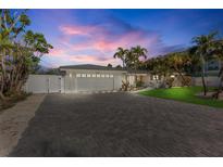 Charming single-story home with a paver driveway, attached garage, and well-manicured lawn at 306 68Th St, Holmes Beach, FL 34217